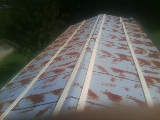 Rusted metal roof panels with new wood purlins before replacement — Storm Damage Roof Repair in San Pedro by Roofing Brothers